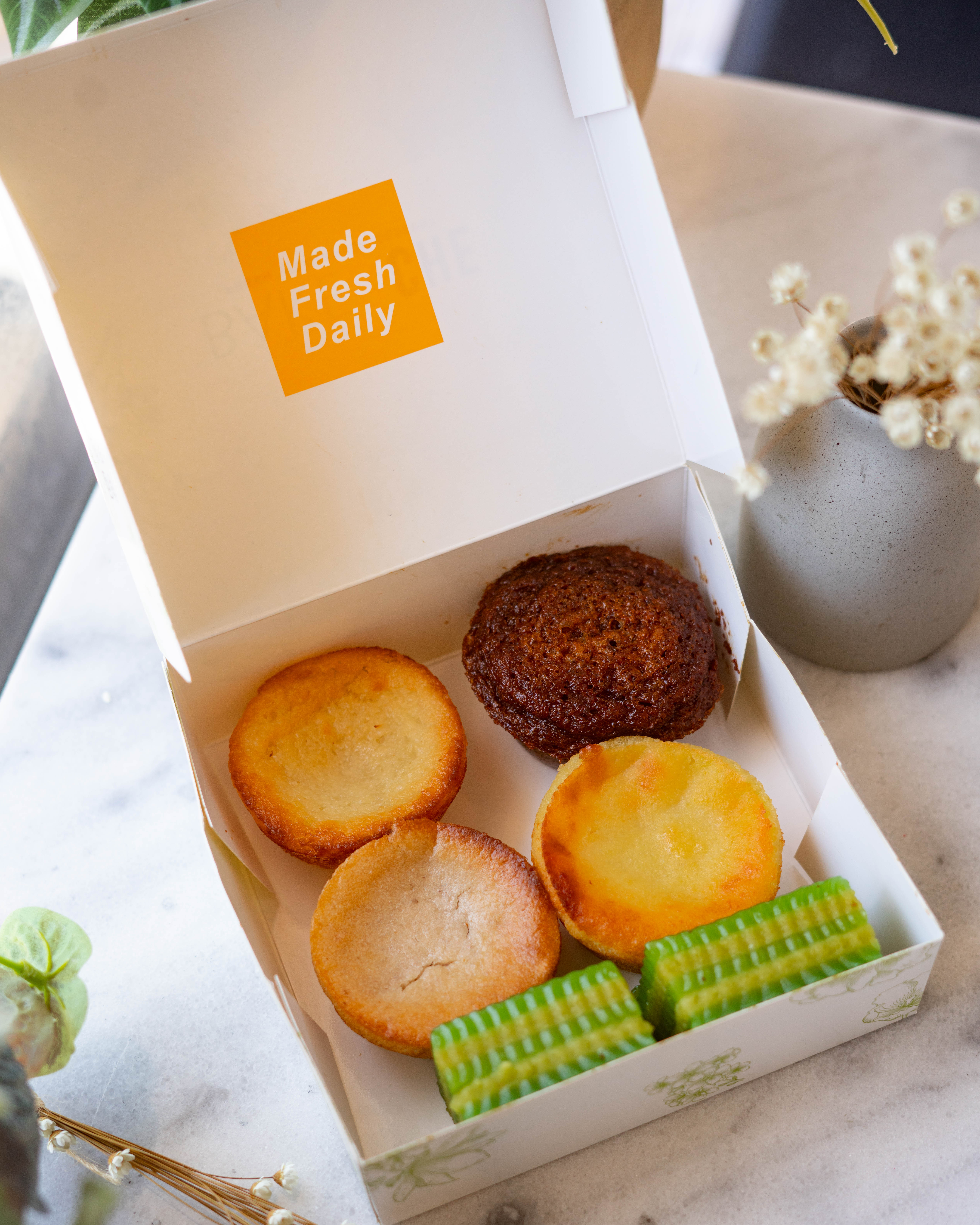 Open Bake & Che cake box with assorted desserts